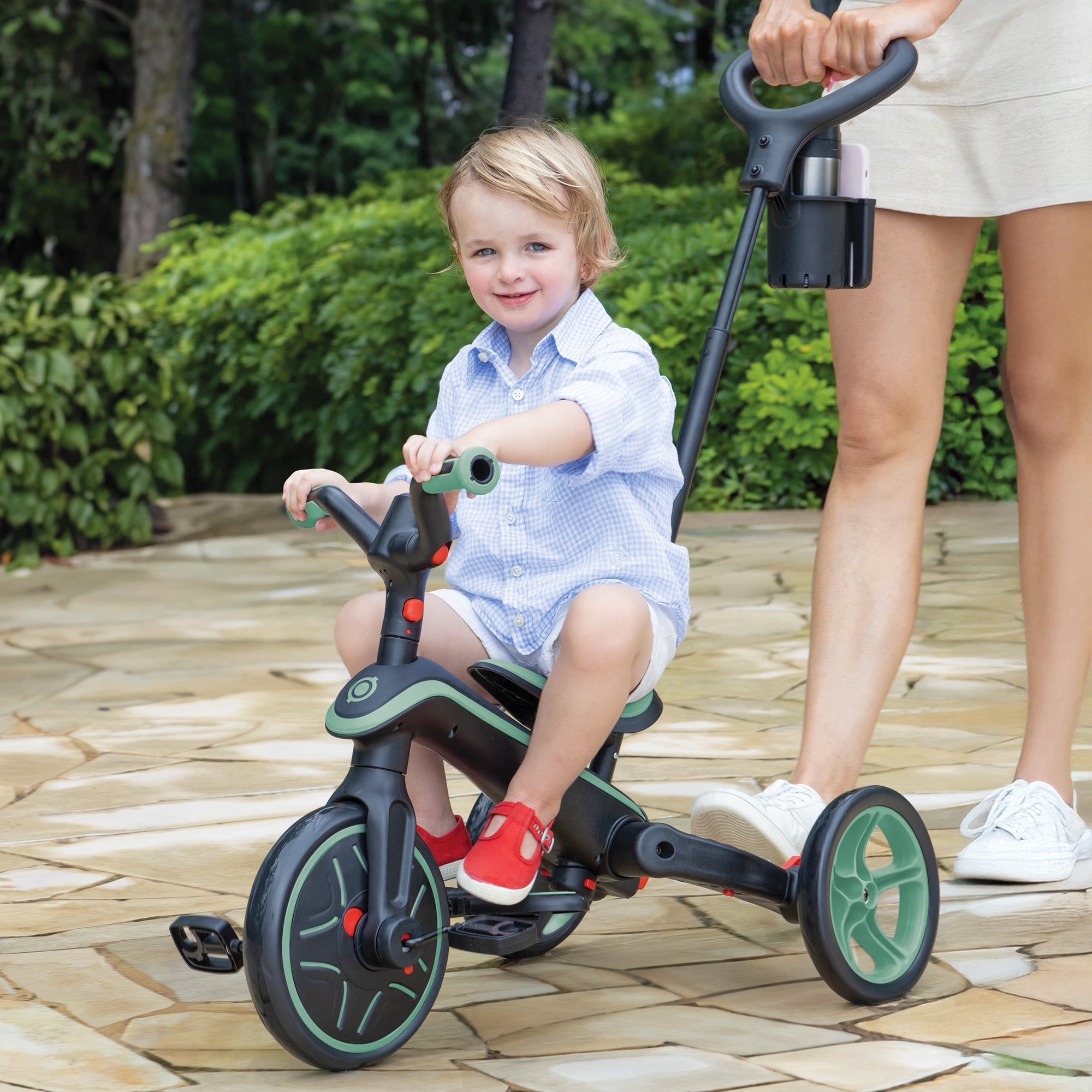 KETTLER Tricycles in front of a home on the gravel