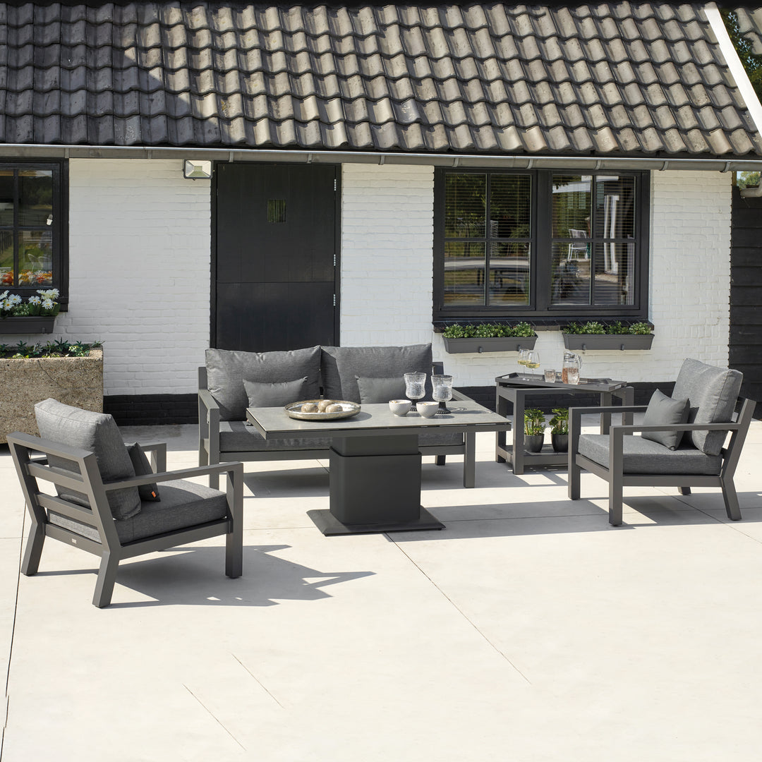 Timber Lounge Set with Adjustable Table featuring charcoal cushions and a sturdy lava frame on a sunny patio.