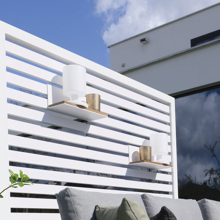 Aluminum Room Divider Accessory Shelf in white with decorative items on an outdoor aluminum room divider panel.