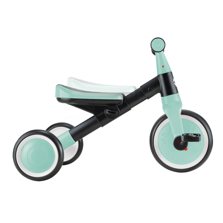 Learning Trike 2-in-1 in mint with adjustable seat, metal frame, and removable pedals for training trike to walking bike transition.