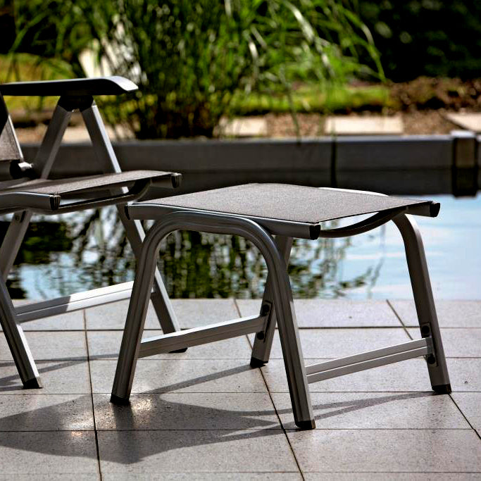 Basic Plus Ottoman with grey anthracite aluminum frame and quick-drying sling, ideal for outdoor use by the pool.