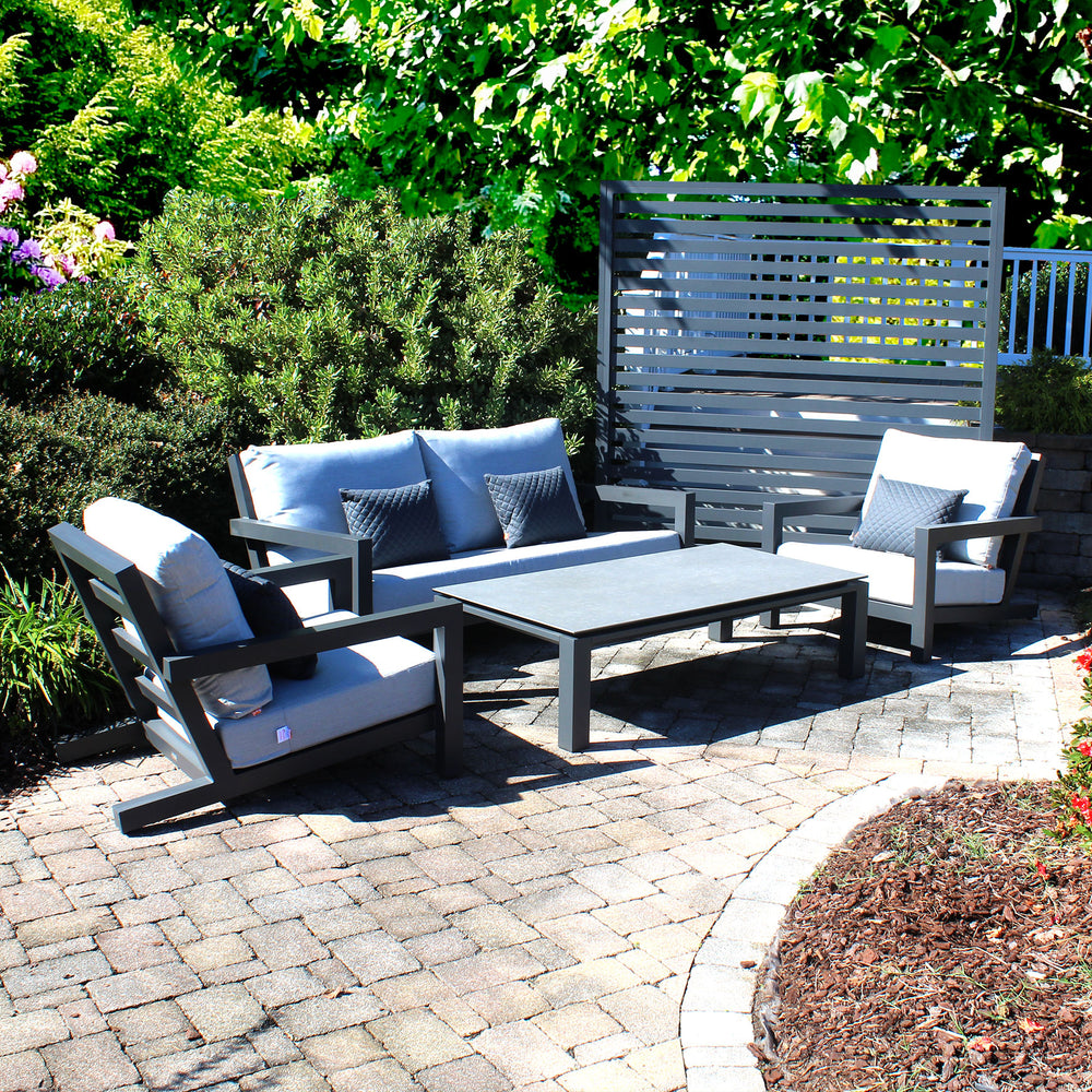 Block Lounge Set outdoor seating with grey cushions, lava frame, ceramic table, and deep angled seating for comfort.