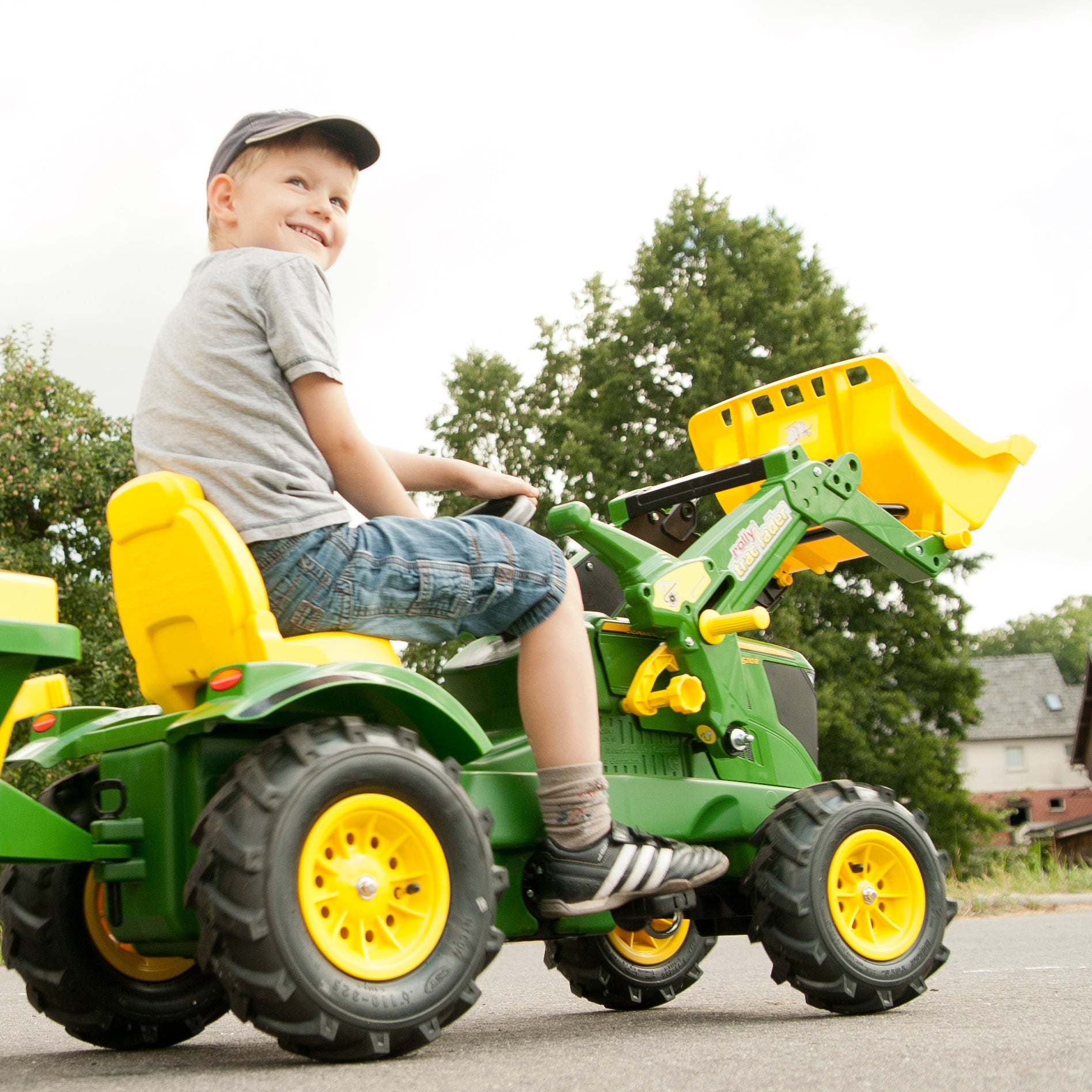 Let your child's imagination soar with the John Deere Farm Tractor. This impressive pedal powered ride on tractor comes complete with front loader that can be raised and lowered, scooped and tipped using the levers. The oversized rubber air tires are long lasting and provide a smooth ride.