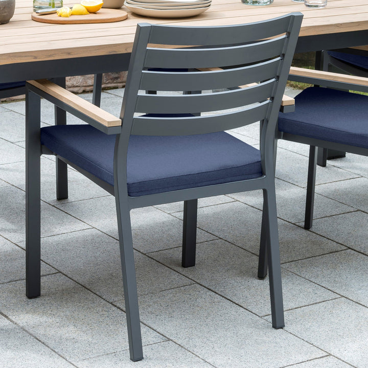 Elba 9-Piece Dining Set Spectrum Indigo charcoal aluminum chair with slat back and indigo cushion on patio