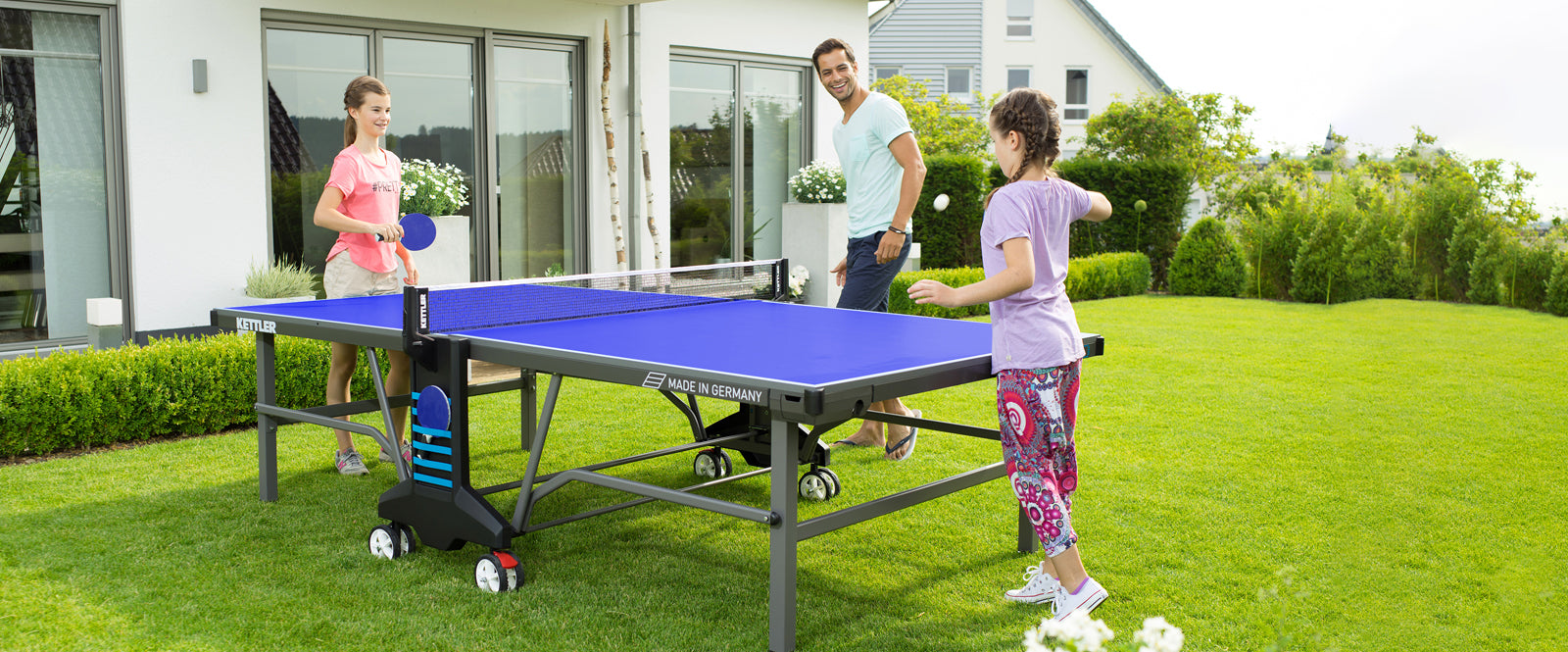 Family Playing Outdoor Table Tennis