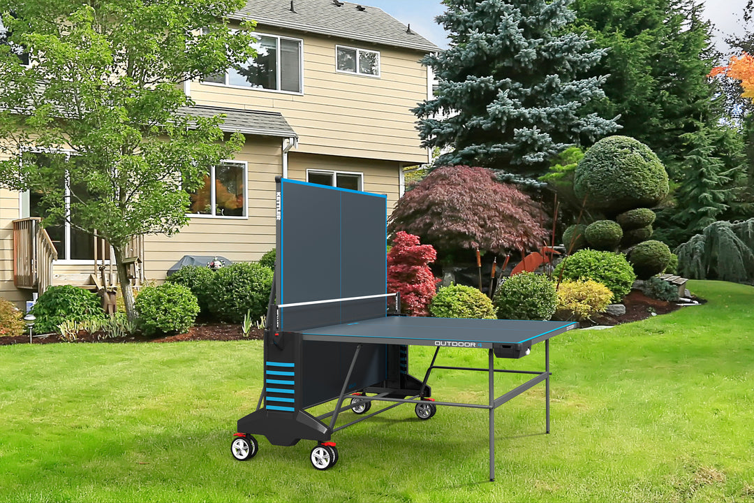 Outdoor 4 Table Tennis Table - 2-Player Bundle shown folded outdoors with weatherproof design and large wheels for easy transport.
