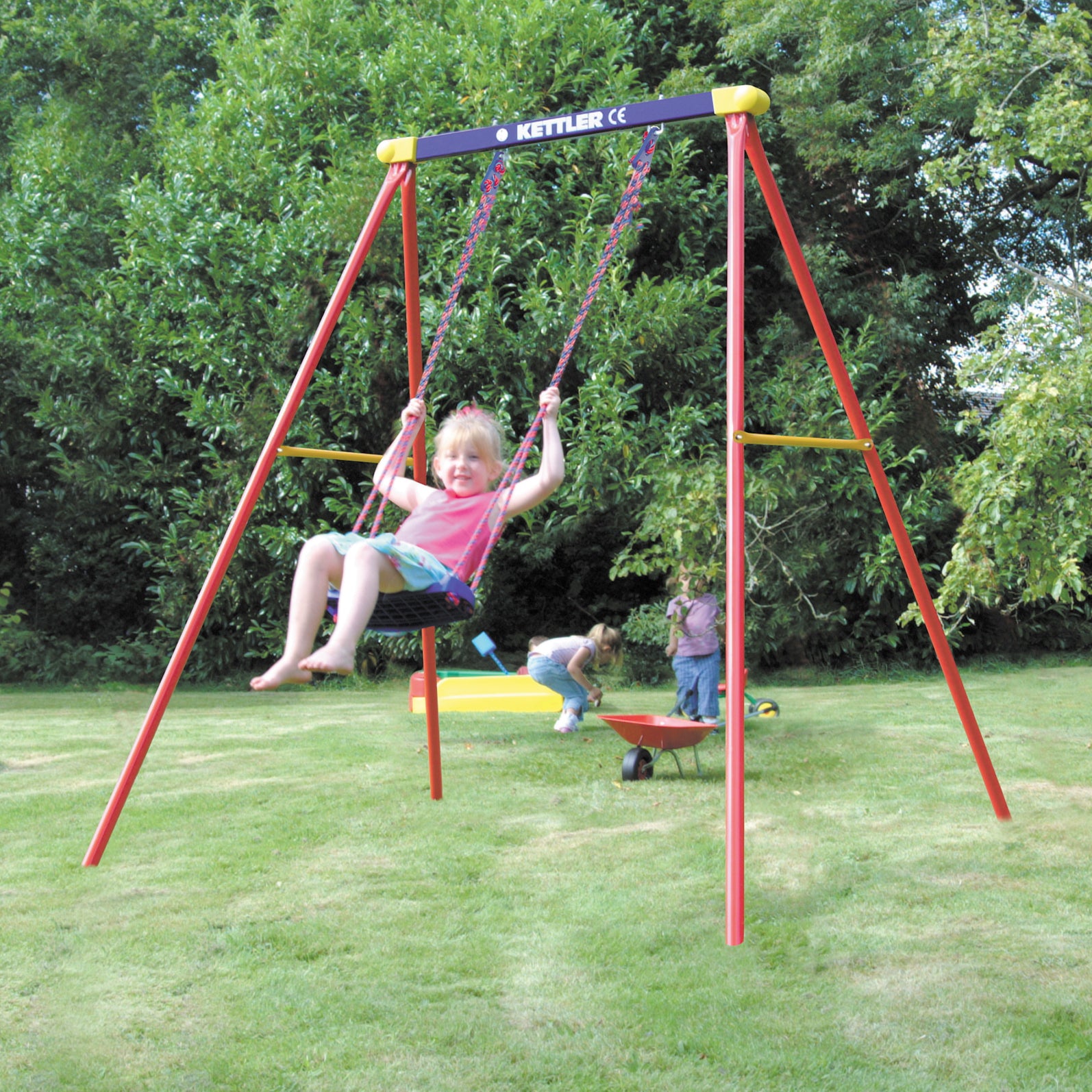 Child swinging on the KETTLER Deluxe Single Swing Set