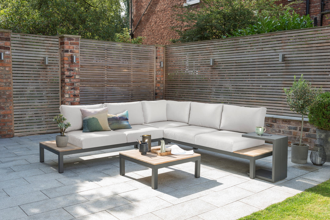 Elba Aluminum 4-Piece Corner Set With Teak Accents outdoor patio set with charcoal frame and beige cushions.
