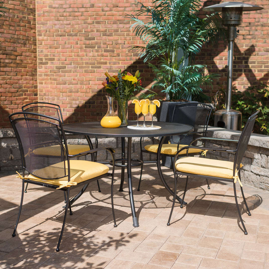 Henley 5-Piece Wrought Iron Mesh Dining Set with 48-inch round table and four stackable iron grey chairs.