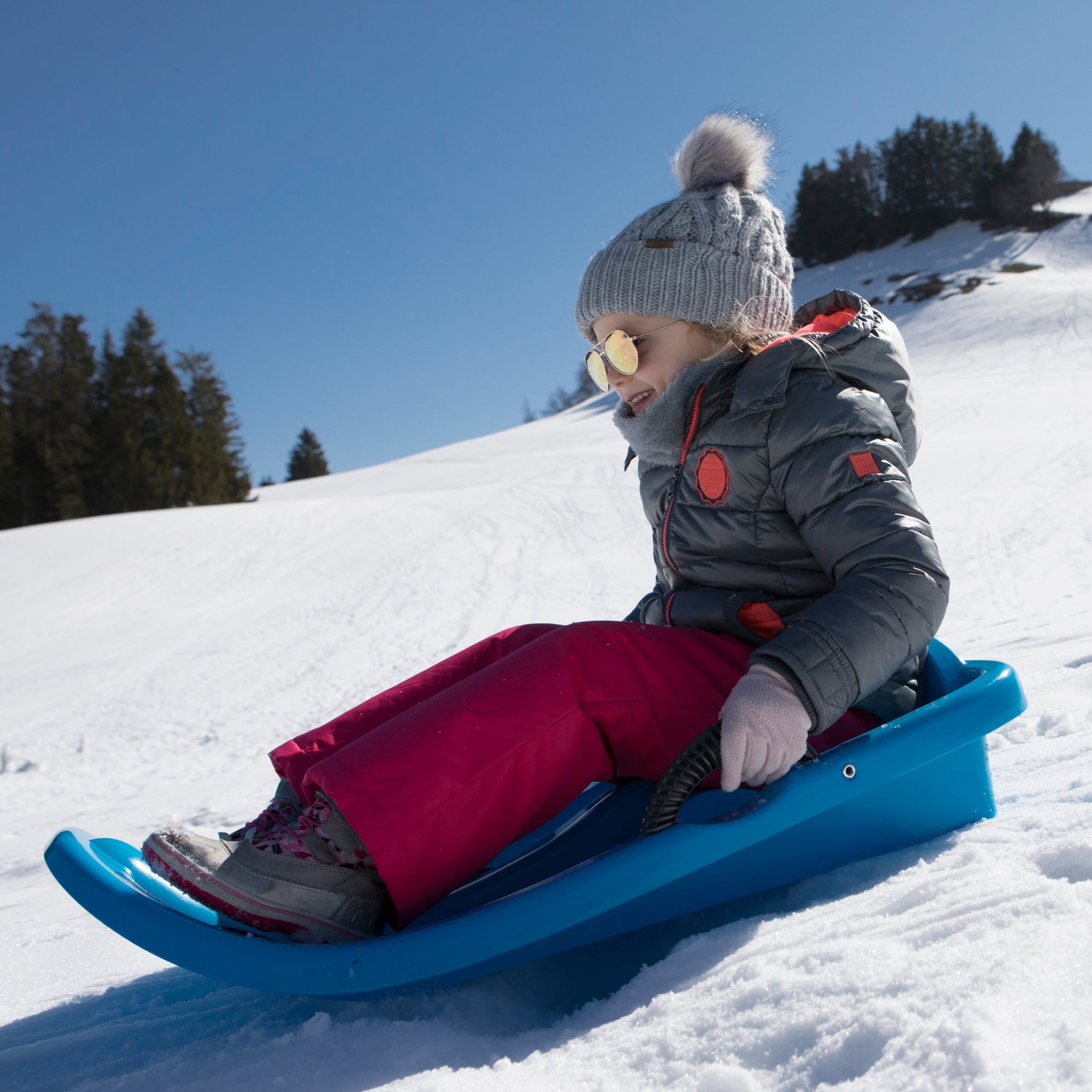 Child sledding on snow