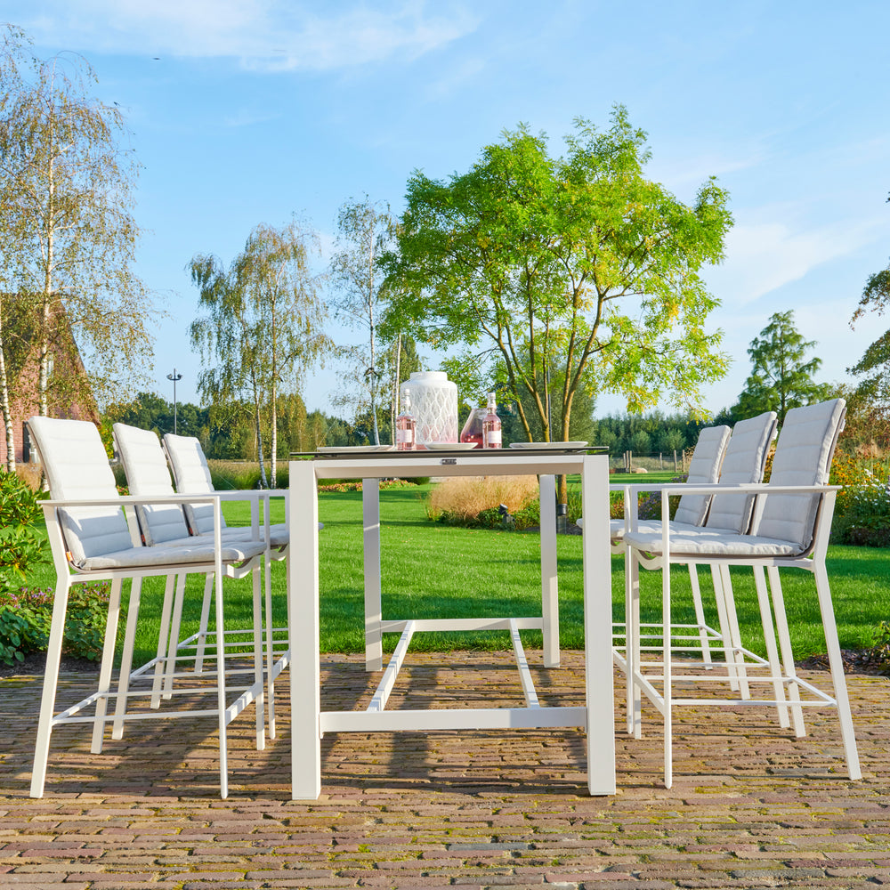 Primavera 7-Piece Bar Set - White outdoor bar set with six sling chairs and a ceramic top bar table on a patio.