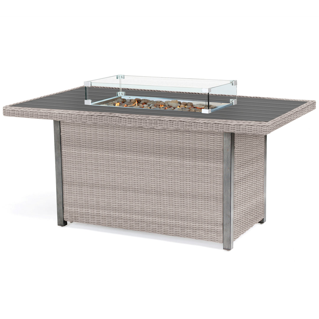 Palma Fire Table with rattan wicker frame, tempered glass wind guard, stainless steel firepit, and lava rocks centerpiece.
