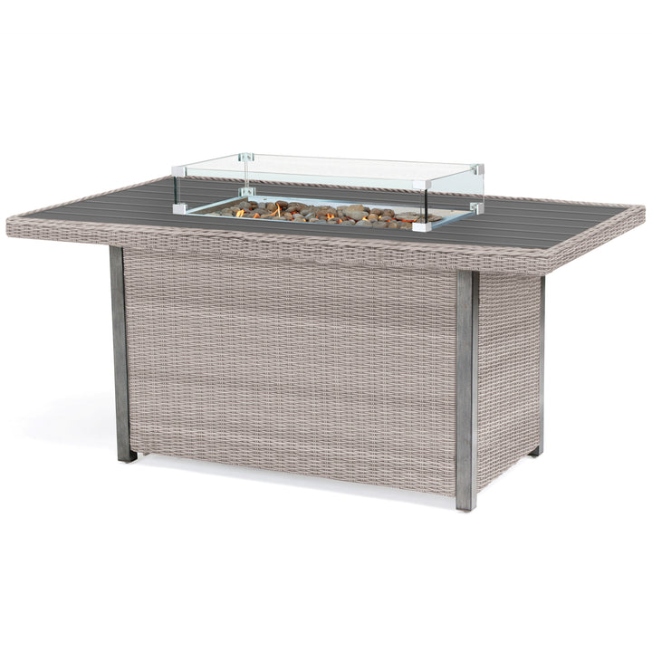 Palma Fire Table with rattan wicker frame, tempered glass wind guard, stainless steel firepit, and lava rocks centerpiece.