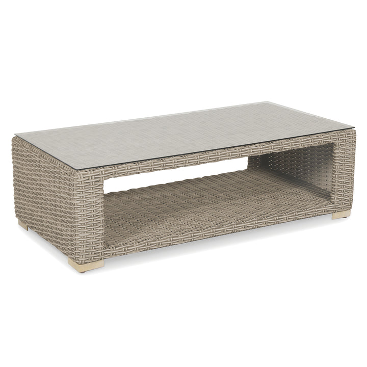 Palma Luxe Lounge Set coffee table with tempered glass top, handwoven oyster weave, teak feet, and storage shelf.