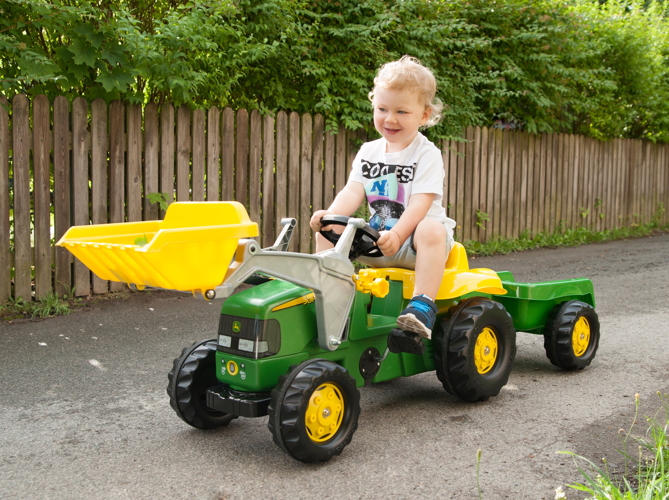 Child rides John Deere Pedal Tractor