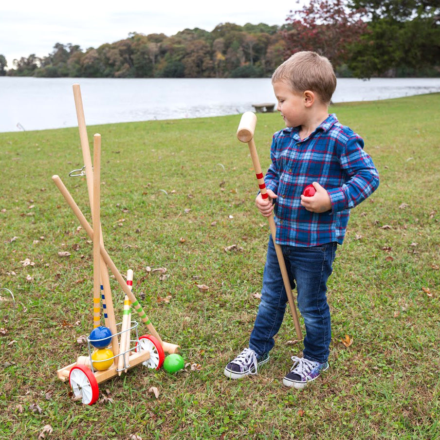 Child playing with the 4-Player Croquet with Trolley