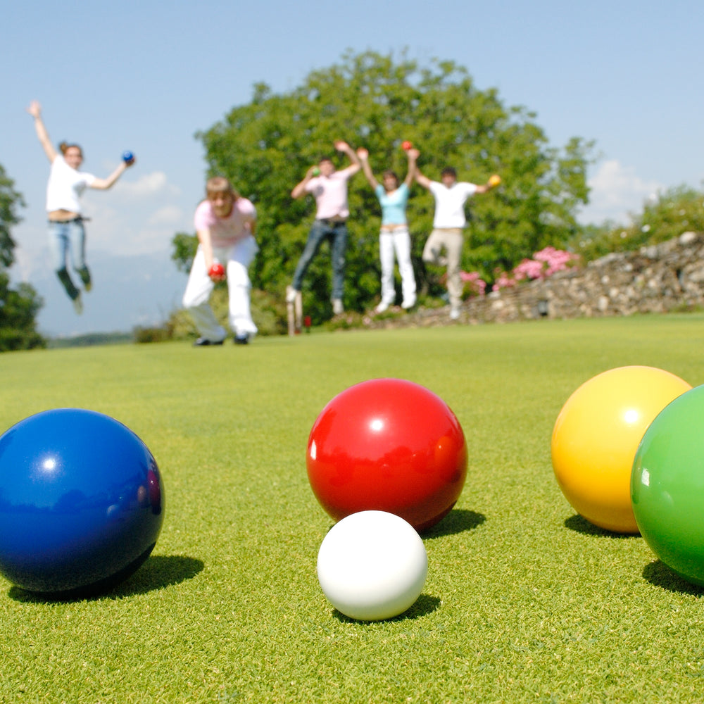 Junior Bocce Set with colorful wooden balls and jack ball ready for outdoor family fun on green lawn.