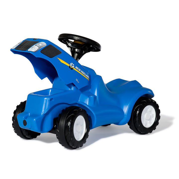 New Holland Minitrac blue ride-on toy with opening hood, squeaky horn, durable tires, and knee indention for kids 18 months to 4 years.