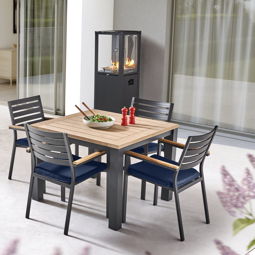 40-inch Elba Dining Table With Teak Top featuring a charcoal aluminum frame and teak surface in an outdoor setting.