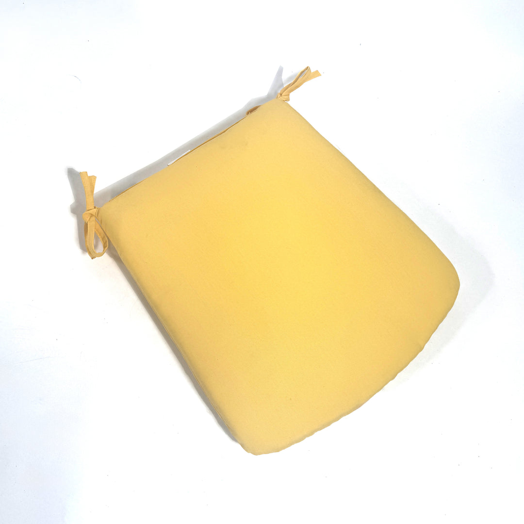 Yellow cushion with a strap on a white background