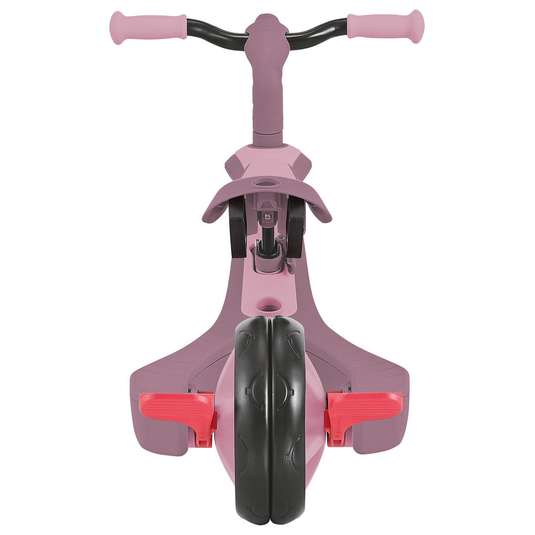 Explorer Trike Eco 4-in-1 front view showing pink frame, red pedals, and black front wheel for versatile child riding modes.