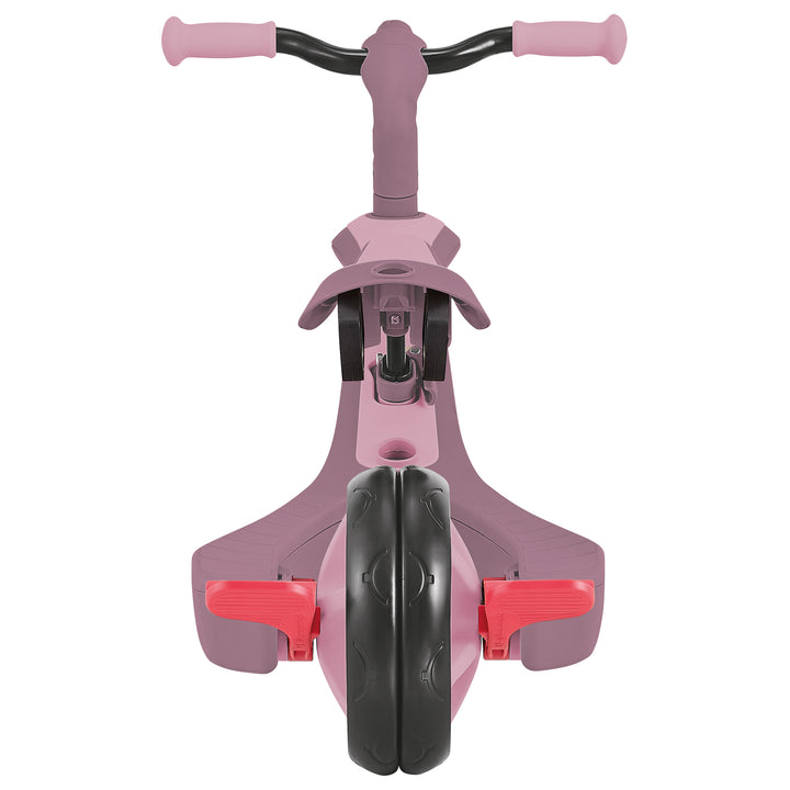 Explorer Trike Eco 4-in-1 front view showing pink frame, red pedals, and black front wheel for versatile child riding modes.