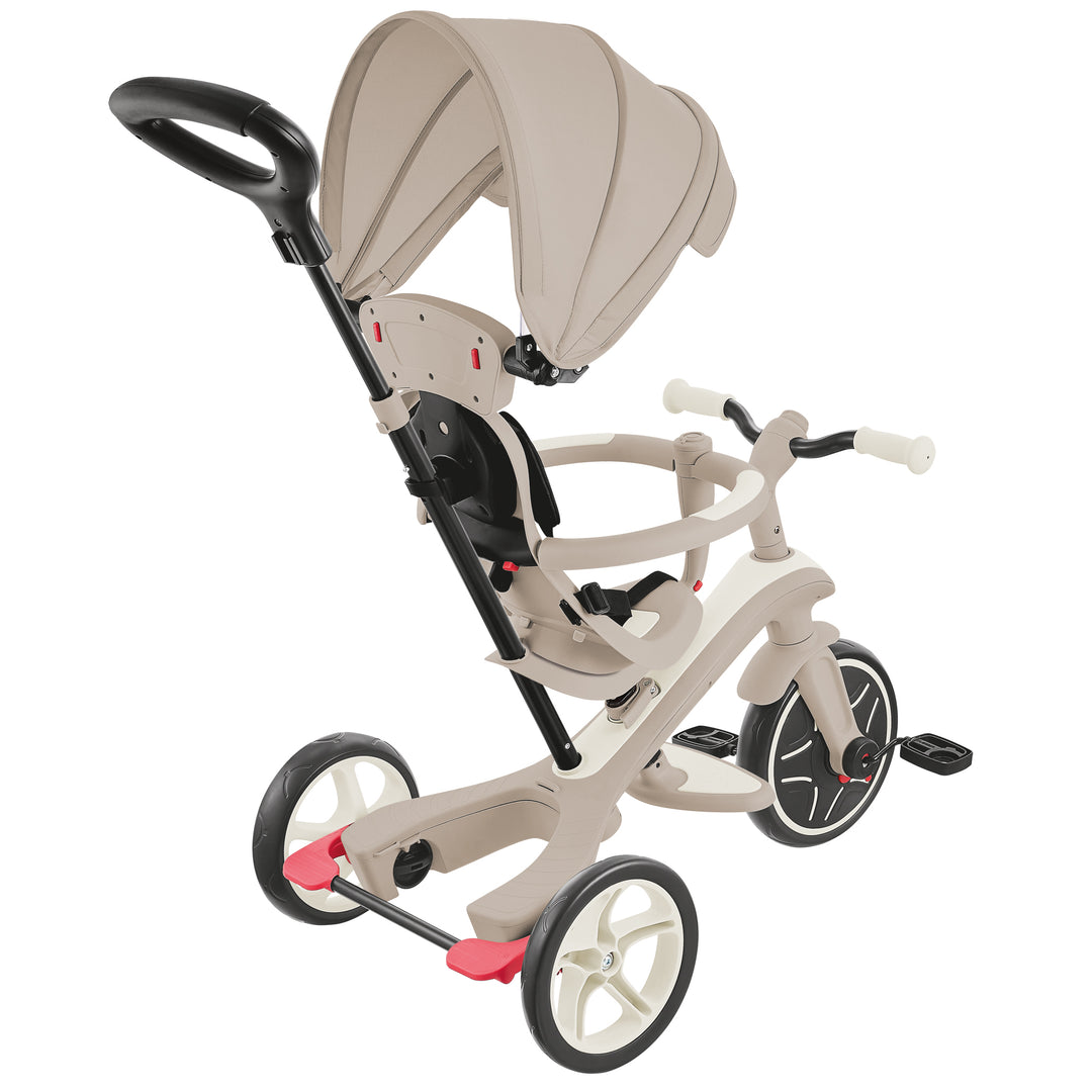 Explorer Trike Eco 4-in-1 beige push tricycle with adjustable canopy, parent handle, safety harness, and EVA foam wheels.