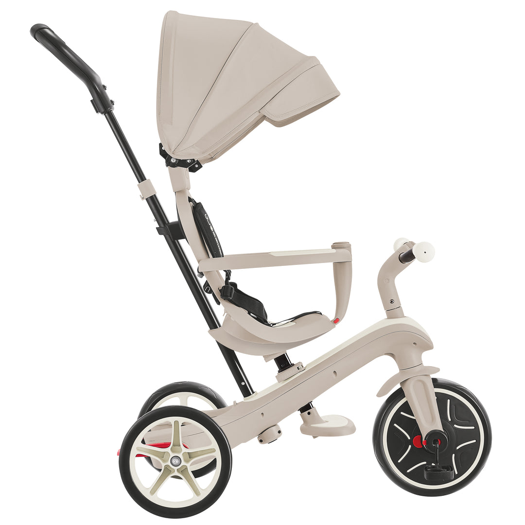 Explorer Trike Eco 4-in-1 in coconut color with adjustable canopy, handle, and seat for ages 10 months to 5 years.