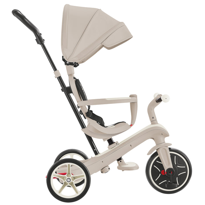 Explorer Trike Eco 4-in-1 in coconut color with adjustable canopy, handle, and seat for ages 10 months to 5 years.