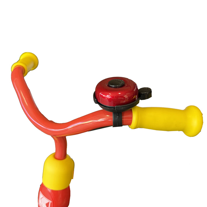 Red and black bicycle bell on a red and yellow trike handlebar 