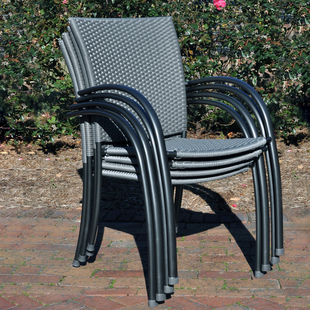 Pilano Woven 5-Piece Wrought Iron Dining Set stacked silver grey woven chairs with iron grey frames outdoors.