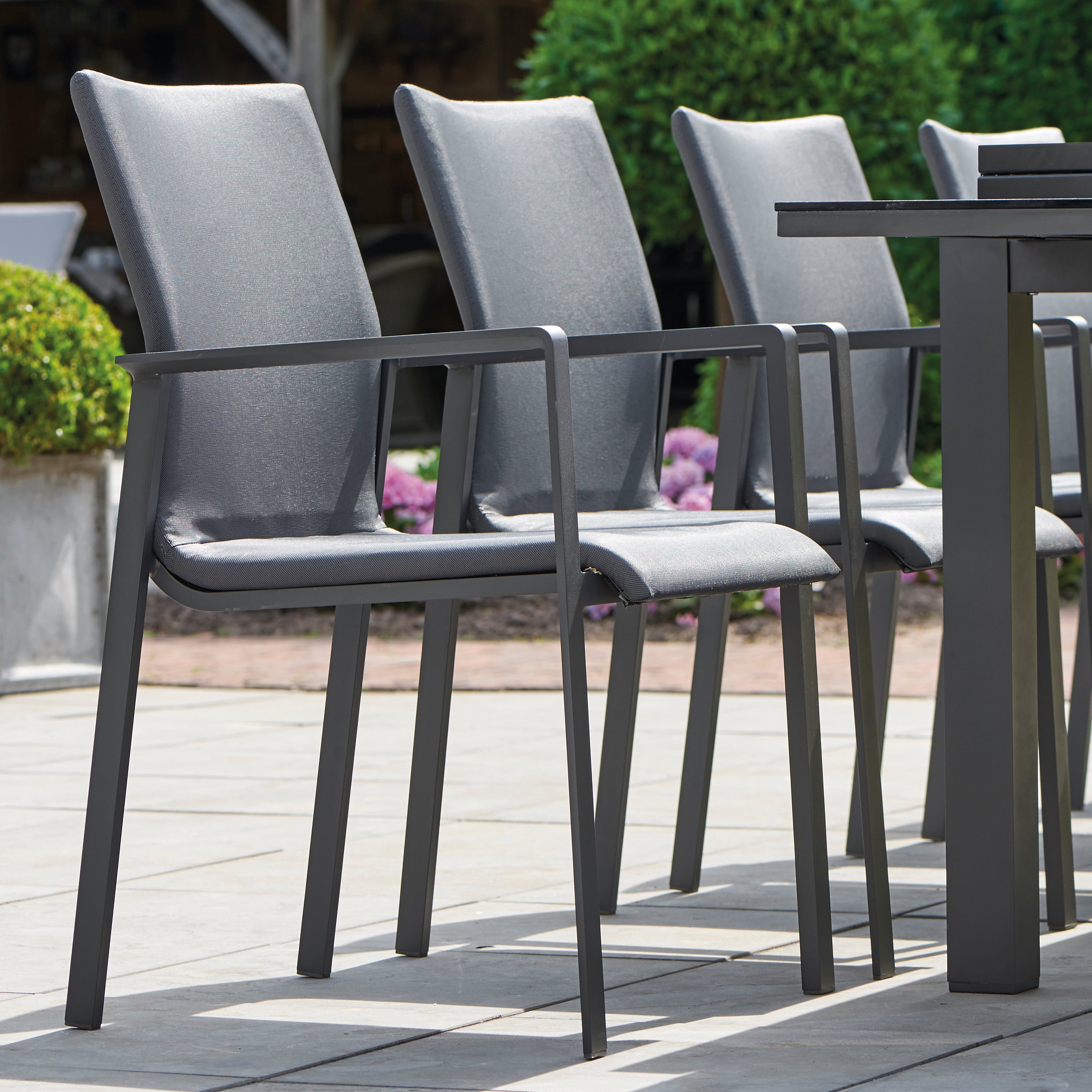 Dine alfresco in style with the Sense Dining Set. The sleek profile of the table and chairs give a clean, contemporary look. The dining chairs feature an aluminum frame with ergonomic arm rests and a comfortable all-weather sling with quick dry foam filling and all weather upholstery fabric. The ceramic top aluminum table is sturdy and weather resistant, ensuring years of outdoor dining enjoyment.