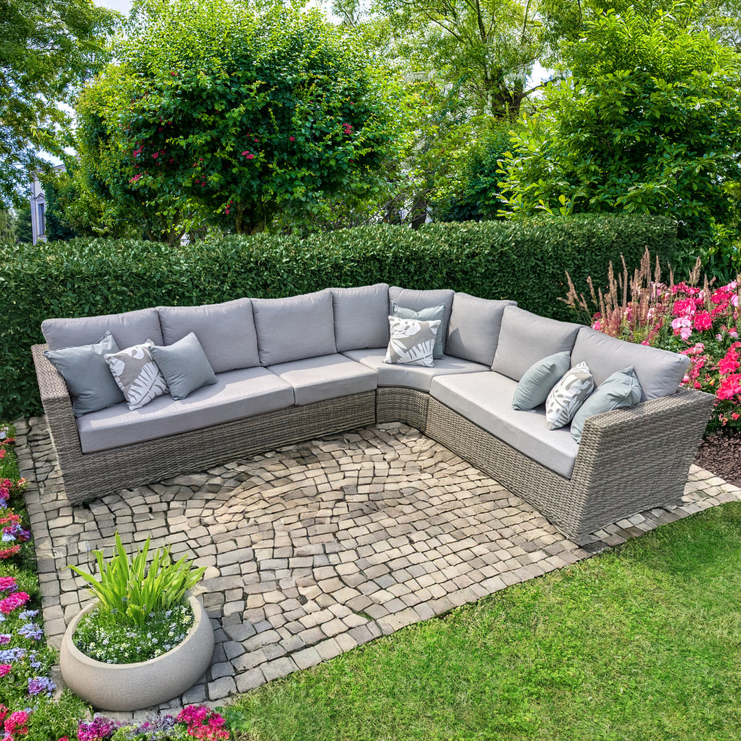 Aya Wicker 4-Piece Corner Sectional With Cushions in yacht grey wicker with grey cushions on garden patio.