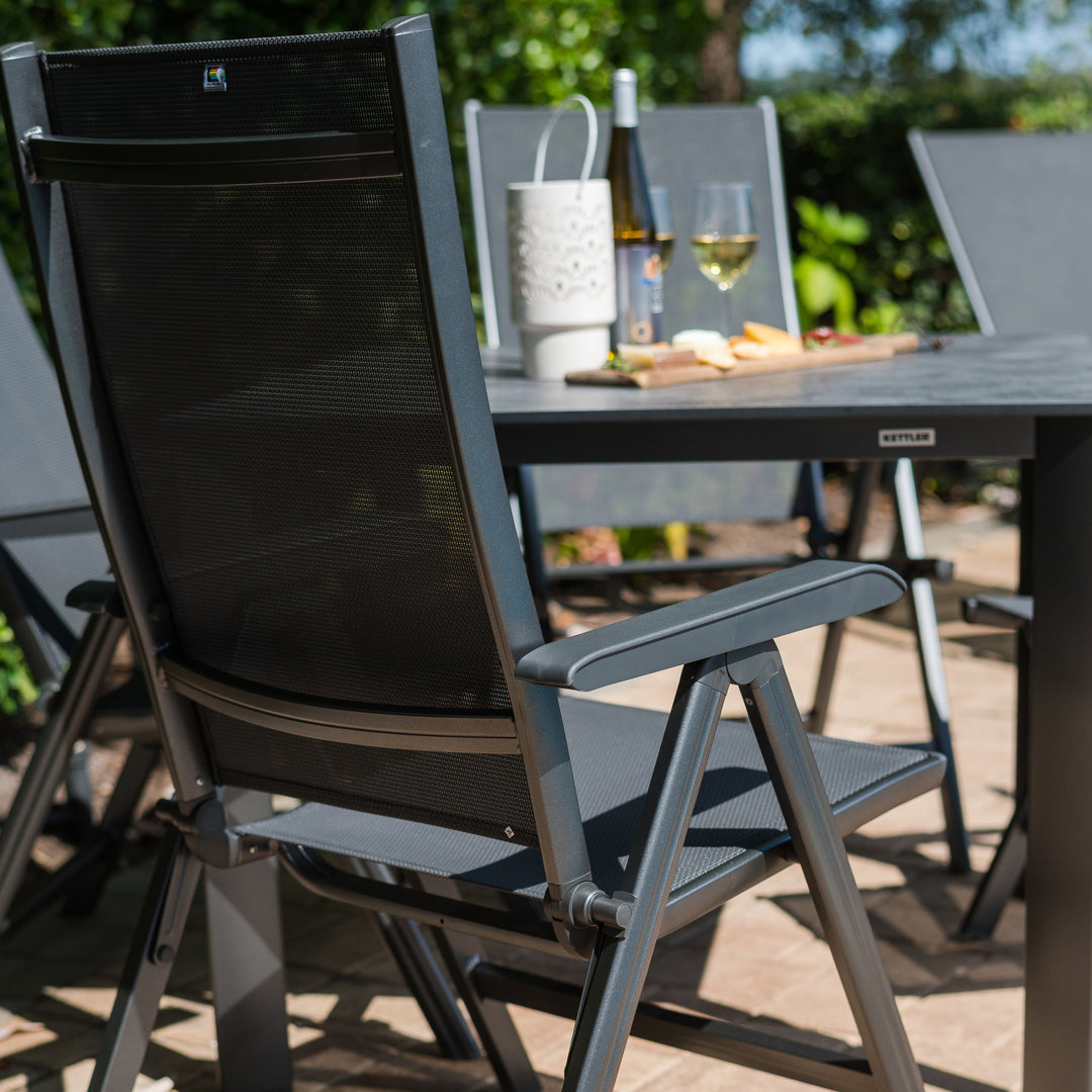 Basic Plus 5-Piece Dining Set with multi-position gray sling chairs and 37" square table with umbrella hole outdoors.