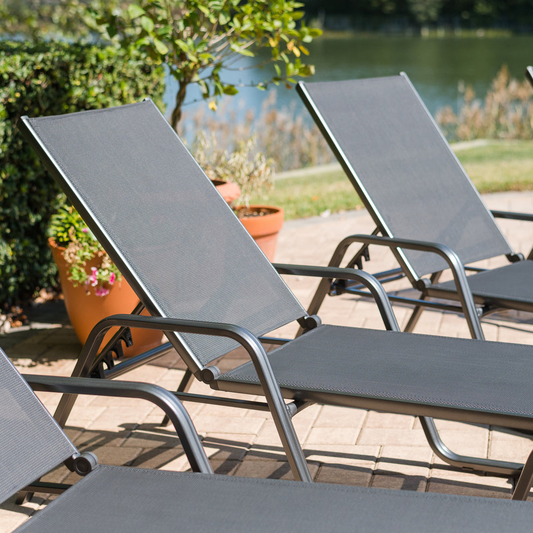 Basic Plus Stackable Loungers in grey with anthracite aluminum frame and textilene sling, ideal for outdoor relaxing seating.