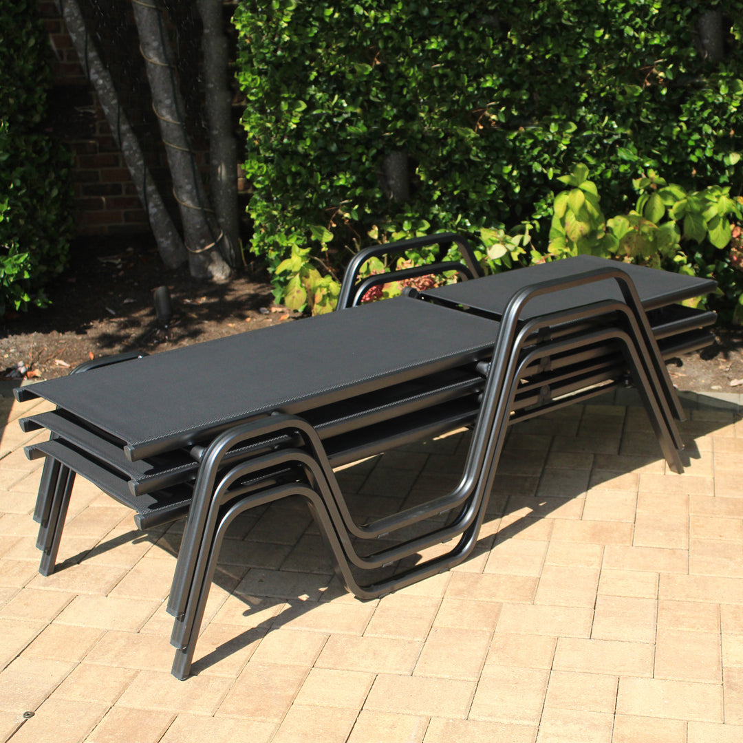 Stacked Basic Plus Stackable Loungers with grey Textilene sling and powder-coated aluminum frame for outdoor use.