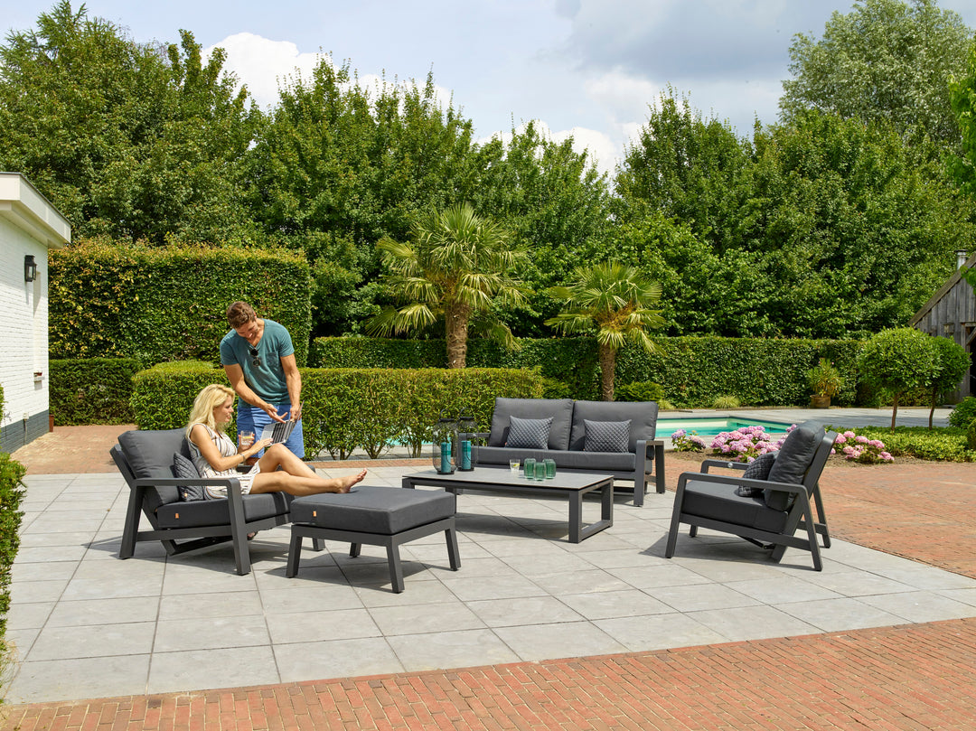 Boston Select Lounge Ottoman in charcoal with powder-coated frame used outdoors as footrest and extra seat.