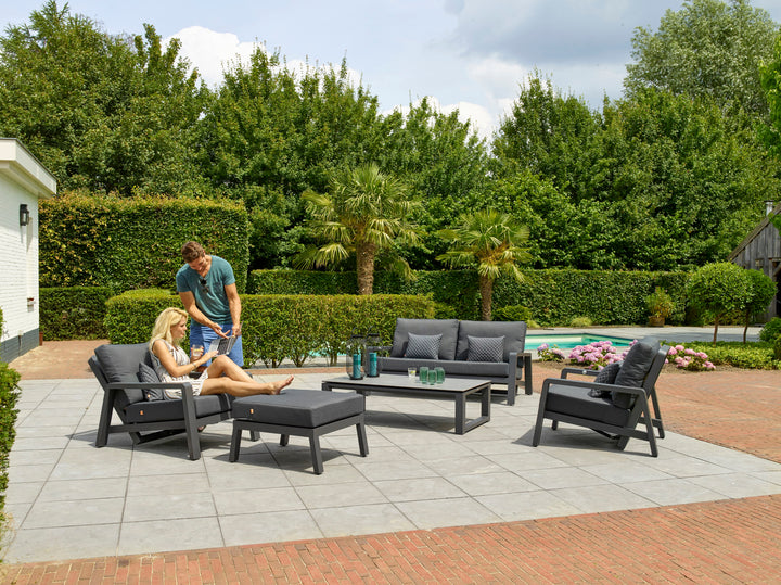 Boston Select Lounge Ottoman in charcoal with powder-coated frame used outdoors as footrest and extra seat.
