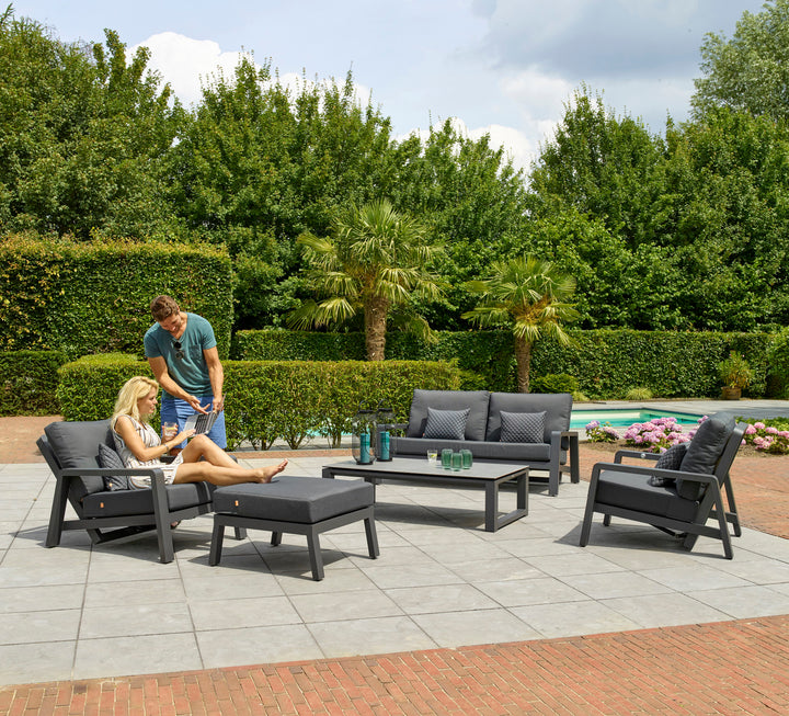 Boston Select Reclining Lounge Chair with charcoal cushions and lightweight aluminum frame in outdoor patio setting.