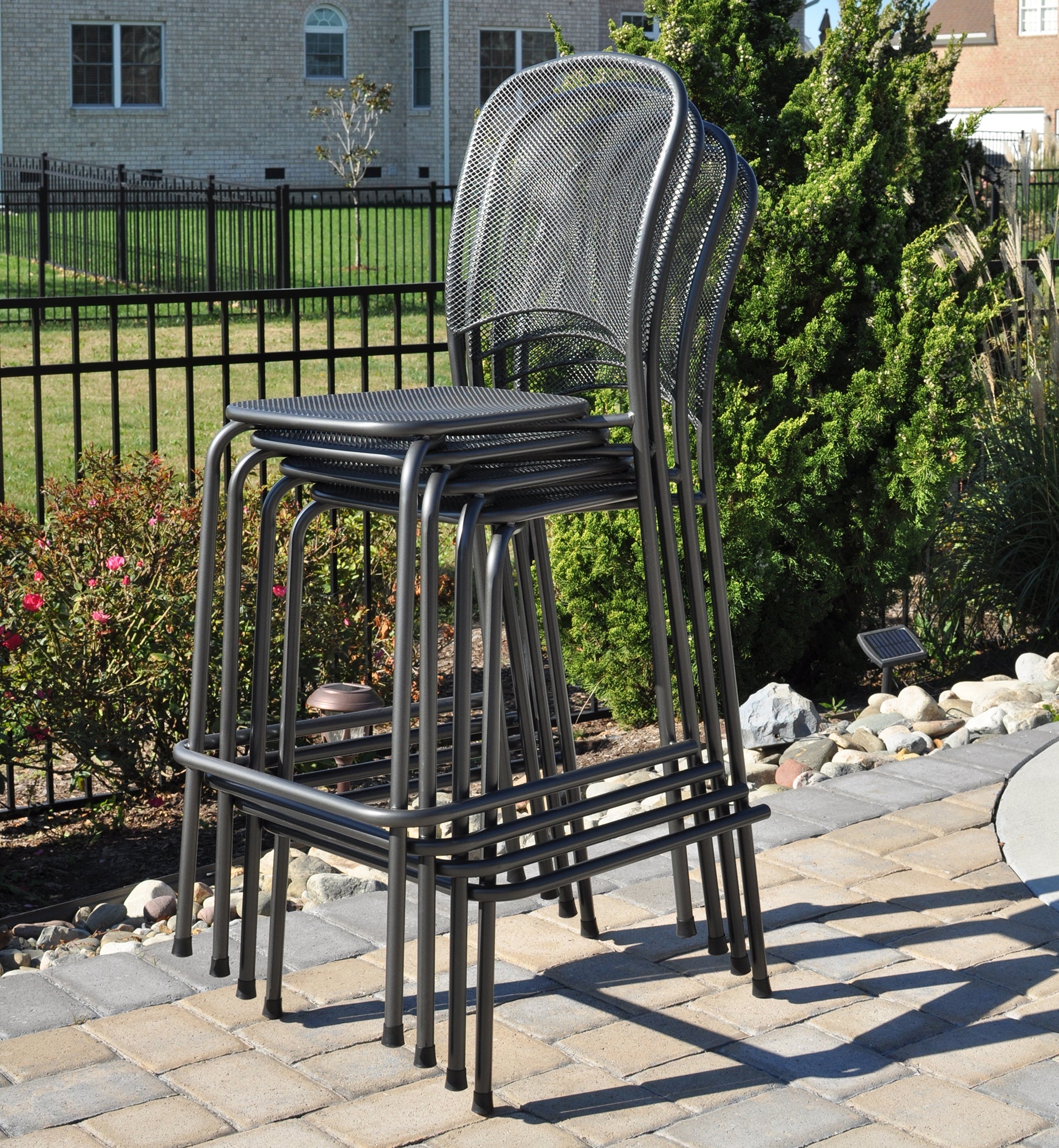 Lifestyle shot of stackable carlo wrought iron bar chair 