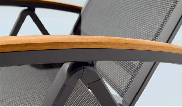 Close-up of Catena Wheeled Folding Lounge Chair showing grey Textilux fabric and teakwood armrest on aluminum frame