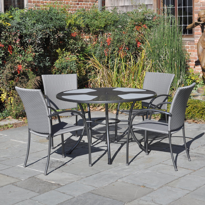 Pilano Woven 5-Piece Wrought Iron Dining Set with silver grey woven chairs and 48-inch round table outdoors