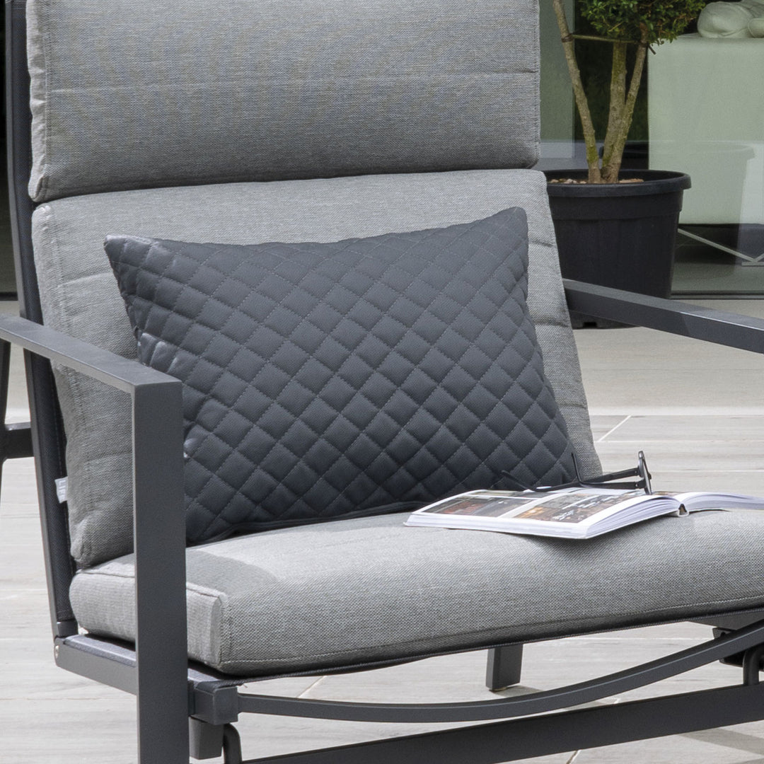 Diamond Pillow in carbon color with textured diamond embroidery on outdoor chair cushion.