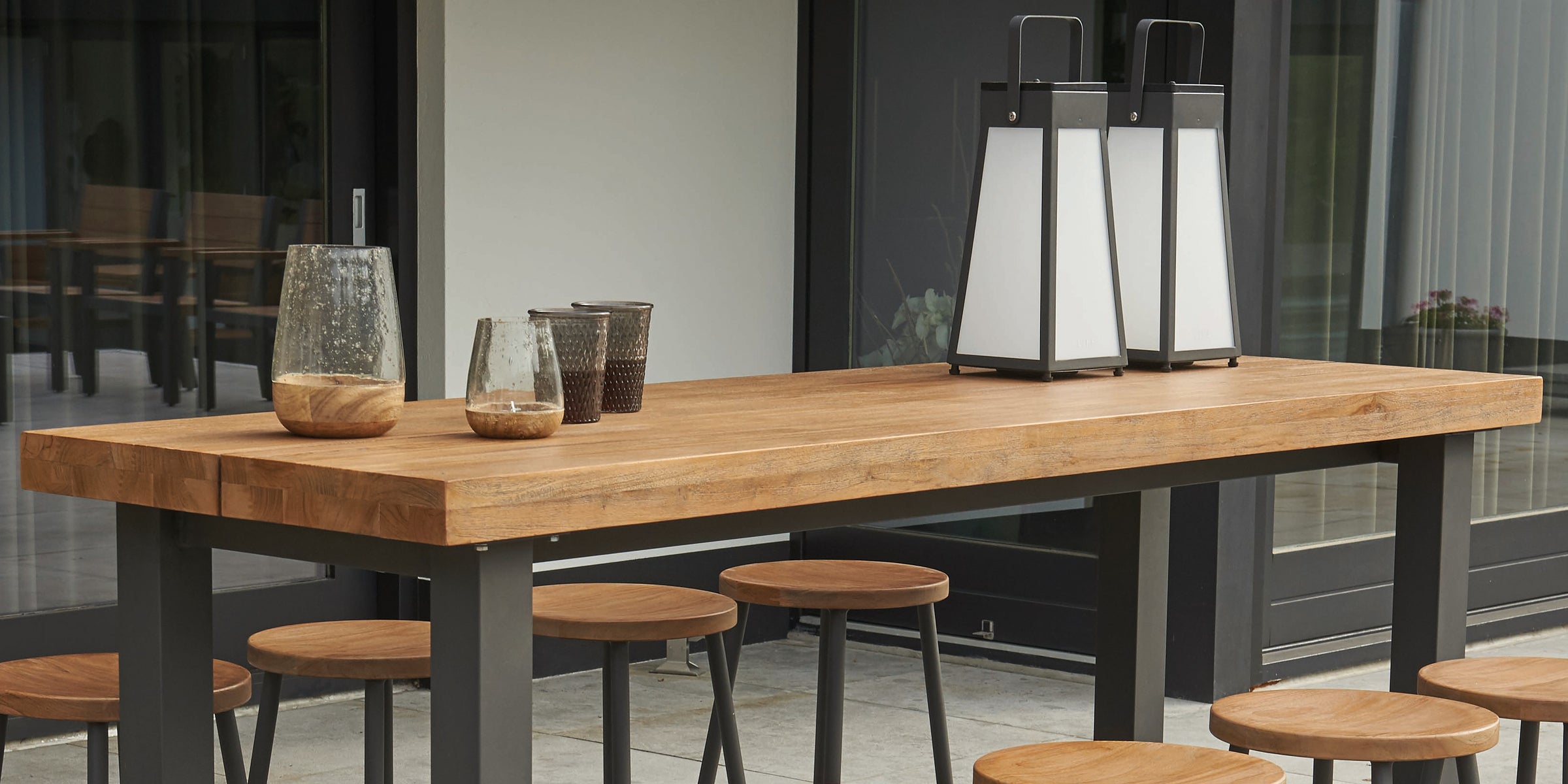Teak accents with aluminum frame create a great modern look for your patio furniture.
