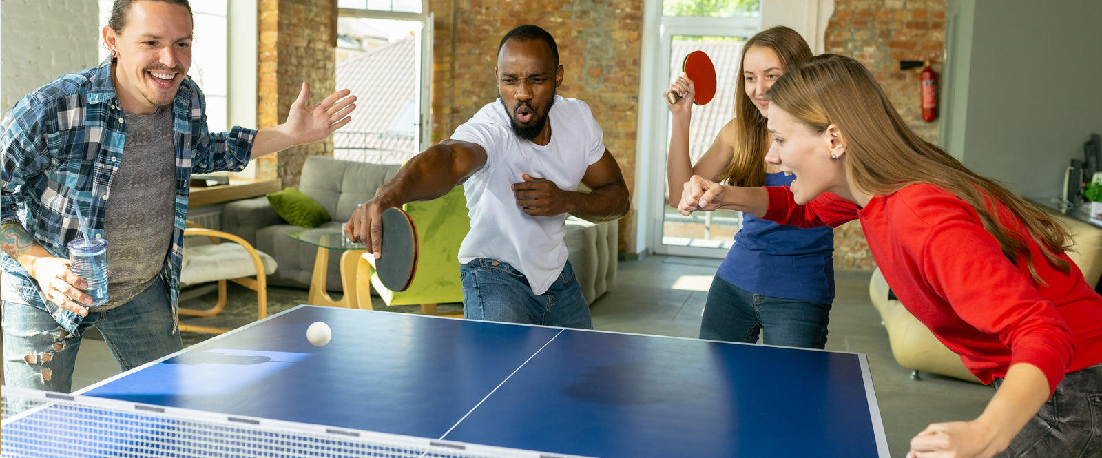 Teens playing Table Tennis Ping Pong having fun