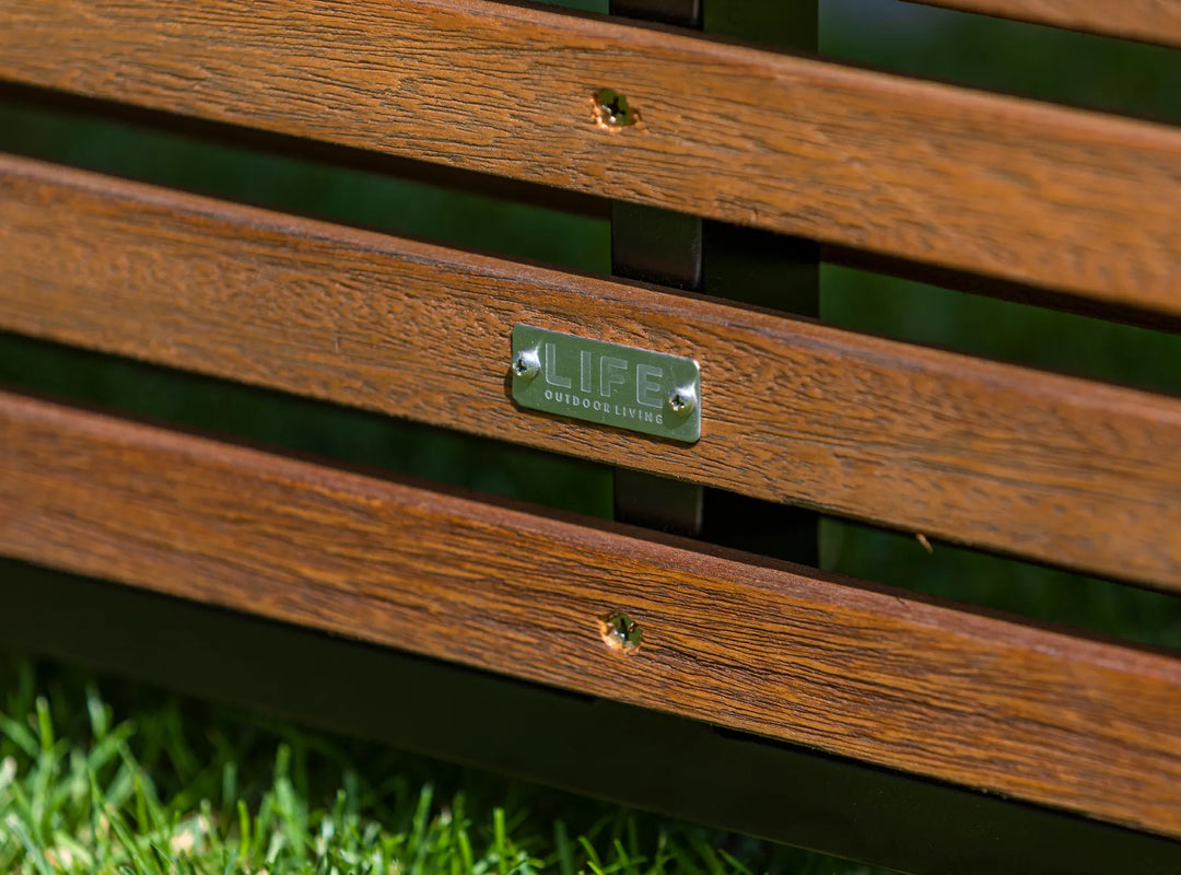 Java Teak Room Divider close-up of robust teak wood slats and metal plate on green grass background.