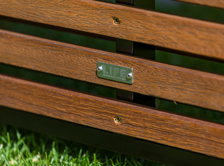 Java Teak Room Divider close-up of robust teak wood slats and metal plate on green grass background.