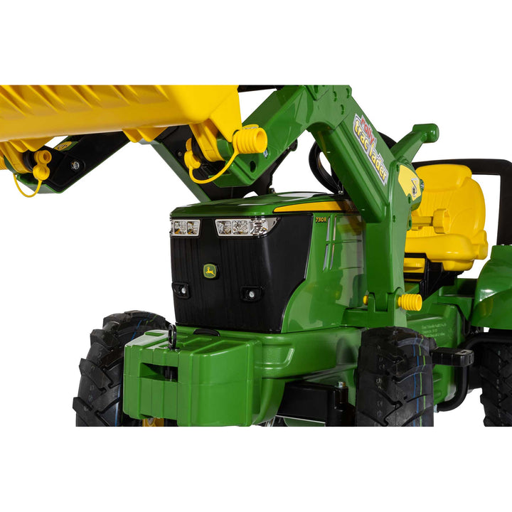 Close-up of John Deere Farm Tractor with Air Tires showing green body, yellow seat, and front loader attachment.