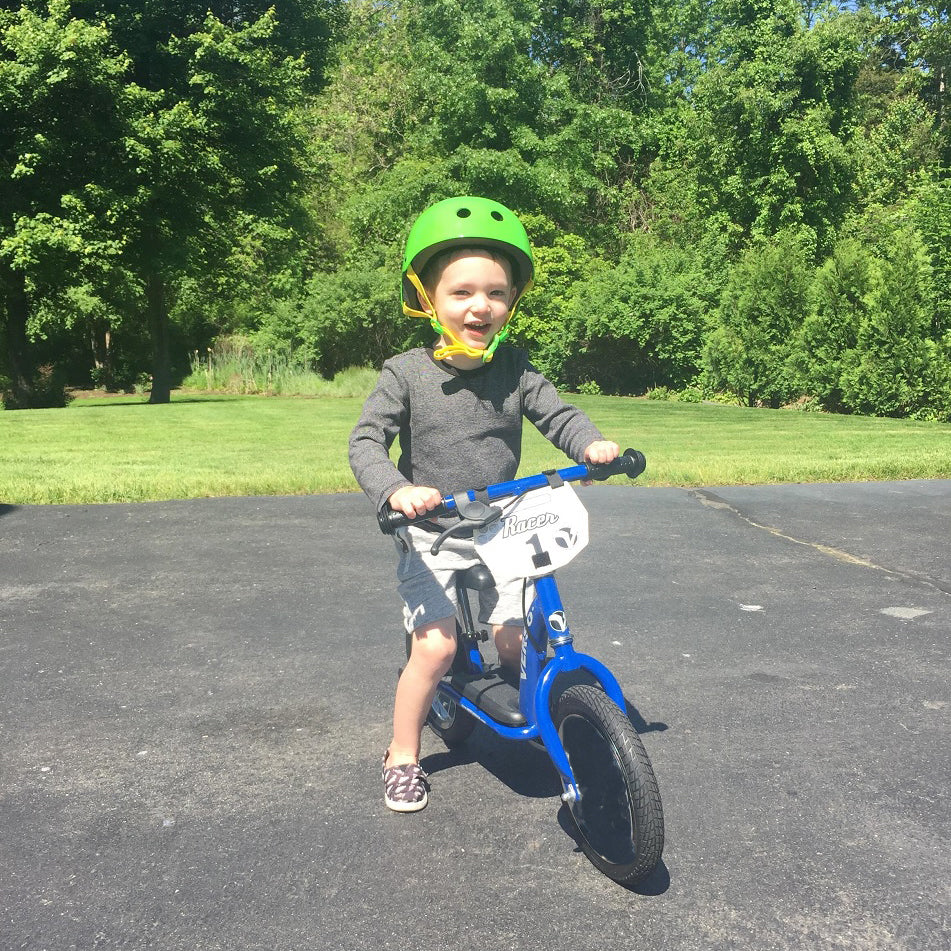 Child riding on the KETTLER 12 Inch Racer Balance Bike