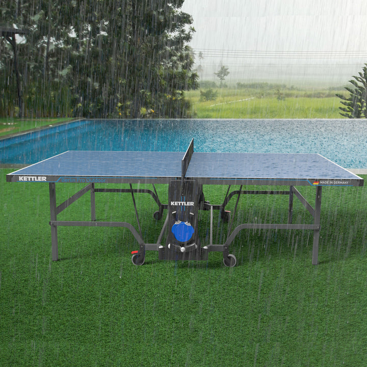 Berlin Pro Outdoor Table Tennis Table 4-Player Bundle with weatherproof top, steel profile apron, and portable design in rain.